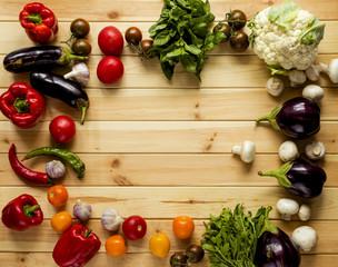 A lot of vegetables on a wooden background. Healthy lifestyle. Assortment of fresh vegetables. Empty place for your text