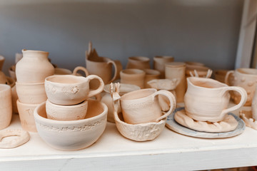 Fototapeta na wymiar Empty clay pots drying on a shelf