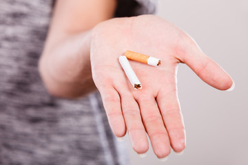 Closeup of broken cigarette on male hand.