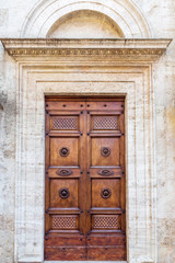 Majestic wooden door in Pienza, Italy.