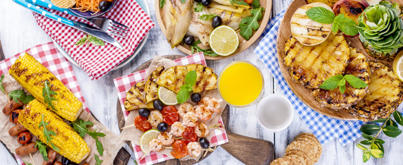 Vegetables, fruits and shrimp on the grill, for a summer lunch. Healthy food. Appetizers on a white background. Copy space. flat lay.