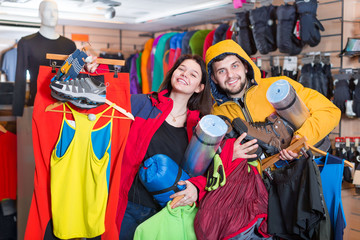 Fototapeta premium Young couple demonstrating tourist equipment