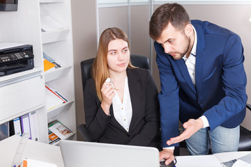 Manager scolding frustrated salesgirl