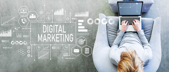 Digital Marketing with man using a laptop in a modern gray chair