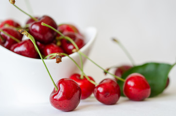 Obraz na płótnie Canvas Cherries isolated. Cherries are in the white bowl on white background.