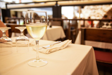 The glass of white wine in street cafe. Space for text
