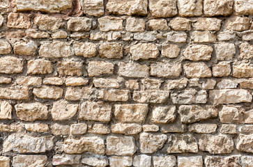 Weathered stone wall as creative background texture