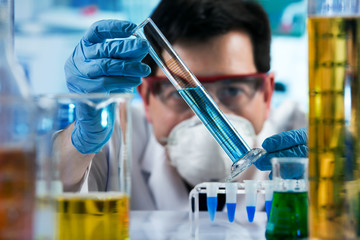chemical engineer working with tube test in the research laboratory / researcher holding test tube...