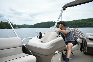 Man Fishing On Board Pontoon