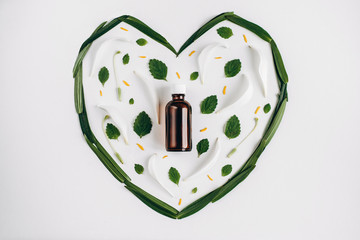 Medicine herb. Bottle of essential oil with grass selection on a white background in the form of a...