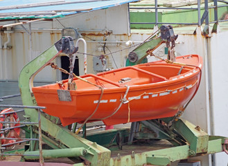 orange lifeboat on ship