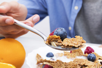 spoon with cereals and fruits, breakfast and healthy snack