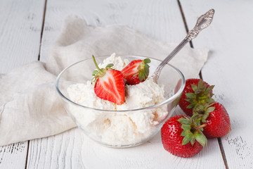 Cottage cheese with strawberries in white bowl