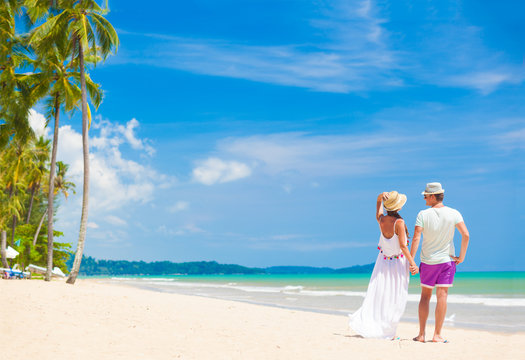 young couple on their honeymoon having fun by tropical beach