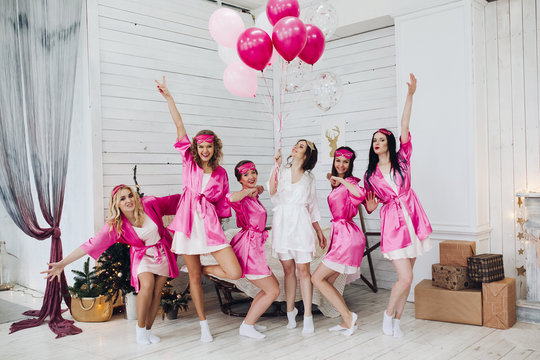 Bridesmaids and bride having fun at bachelorette party.