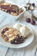 Portion of berry crumble with vanilla ice cream