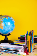 School supplies on blackboard background with copy space.