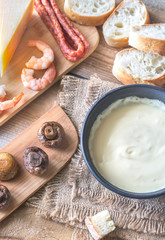 Bowl of fondue with appetizers