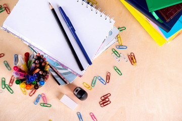 School supplies on blackboard background with copy space. Top view.