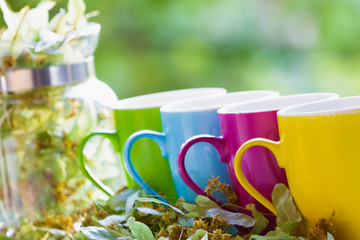 Green tea pot and colorful cups