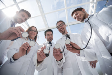 bottom view.a group of doctors have put their stethoscopes together