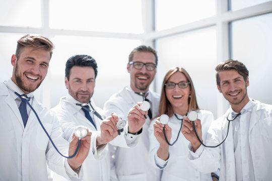 group of doctors hold their stethoscopes