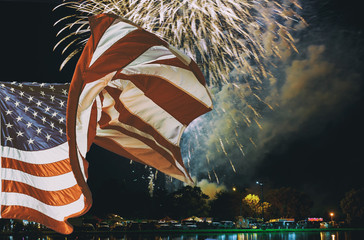 The American flag waving in Sparkling red green yellow celebration fireworks over starry sky. Independence Day, 4th of July, New Year