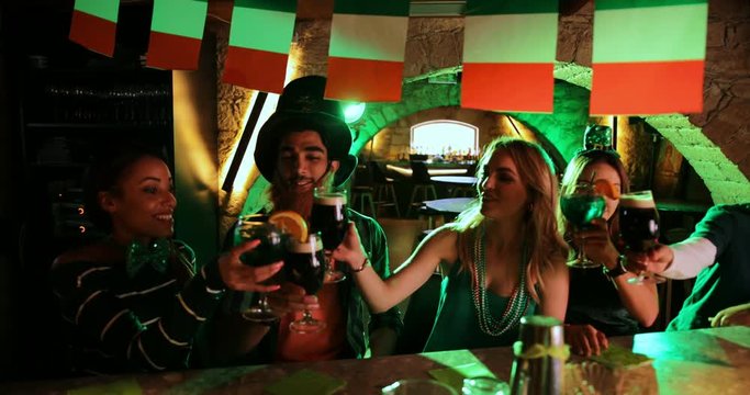 Young multi-ethnic friends celebrating Saint Patrick's day in Irish pub