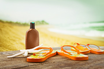 Sunbathing accessories placed on wooden planks at the beach