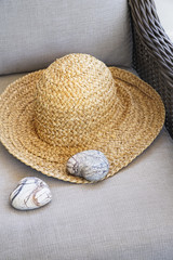  Straw hat with heart shaped rocks on chair