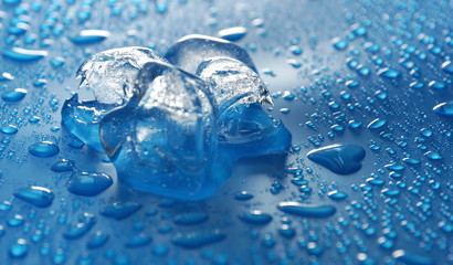 three pieces of ice on a blue water drop background