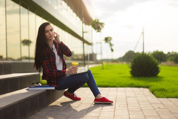 Young brunette woman student working outdoors