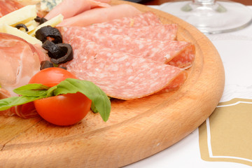 Variety of cold meat, dry cured pork, sausage, salami with cheese and olives