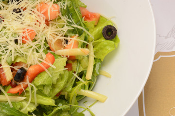 Salad with lettuce, cheese, olives, pepper and tomato