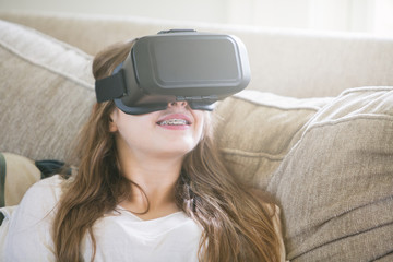 Teeenage girl playing virtual reality video game,