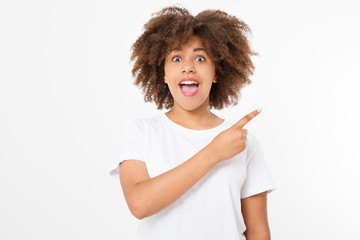 Young african american happy woman showing copyspace pointing on isolated white background. Summer fun. Template, blank shirt. Afro curly hairstyle.