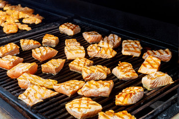 Grilled red fish steak salmon on the grill top view close-up