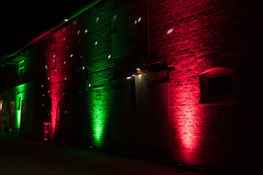red and green dj ambient lighting on a barn at a vintage wedding