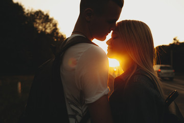 Gorgeous couple hugging gently at sunset