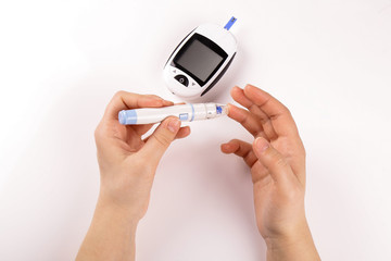 One person with diabetes doing a blood test with a glucometer isolated on white background