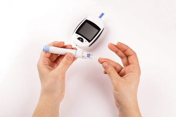 One person with diabetes doing a blood test with a glucometer isolated on white background