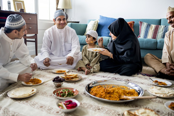 Muslim family having dinner on the floor