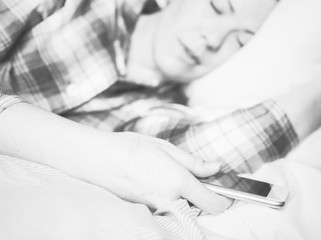 Woman asleep with mobile in hand