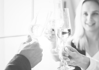Closeup of people clinking wine glasses