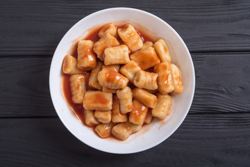Homemade potatoes gnocchi with tomato sauce .