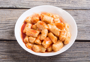 Homemade potatoes gnocchi with tomato sauce .