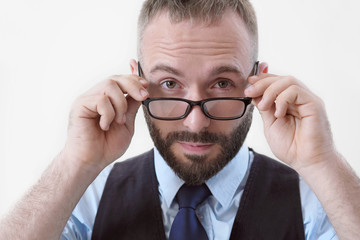 Handsome smart man in glasses and suit with a tie on a white background.