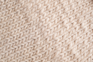  beige texture of knitted wool fabric, background concept