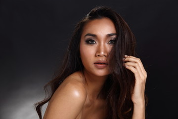Fototapeta premium Asian Long straight black hair tan skin woman in Black dress
