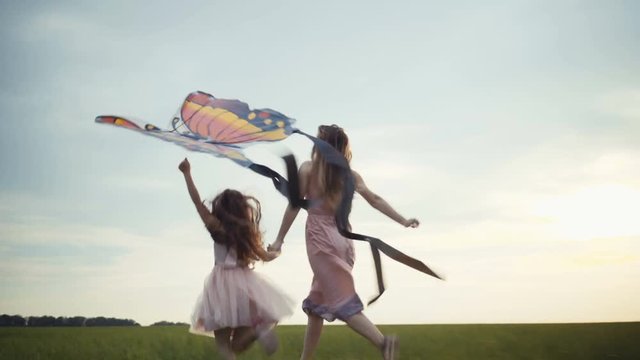 girl running around with a kite on the field. Freedom concept.